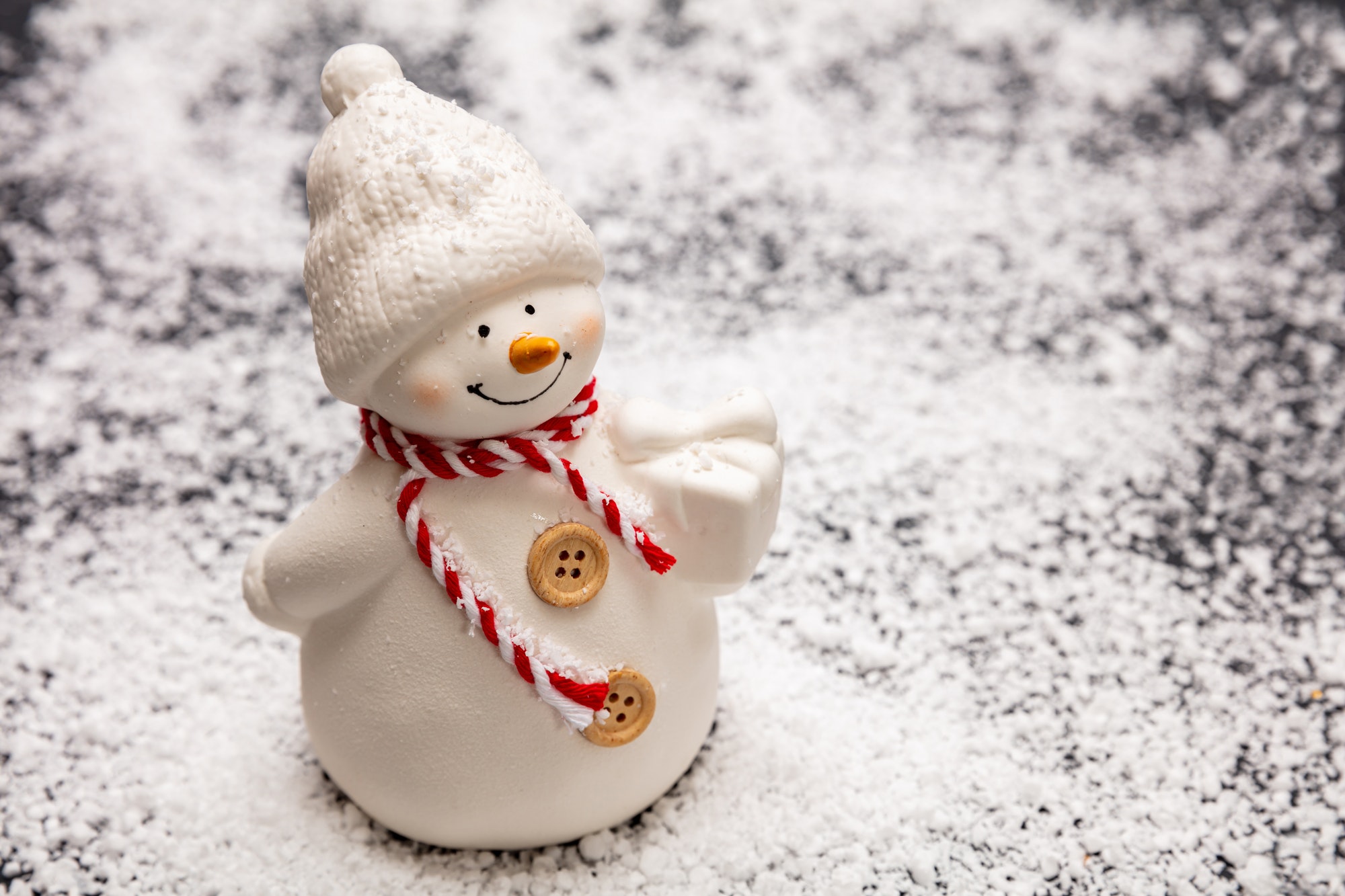 Snowman on snowy background, copy space