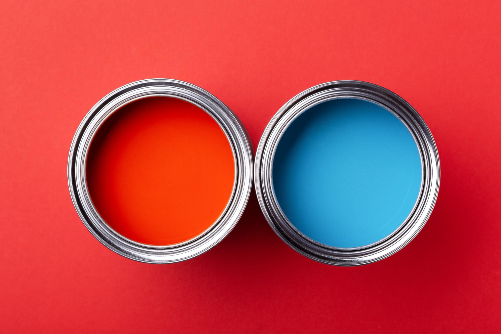 Two Cans of Paint. Red and Blue.